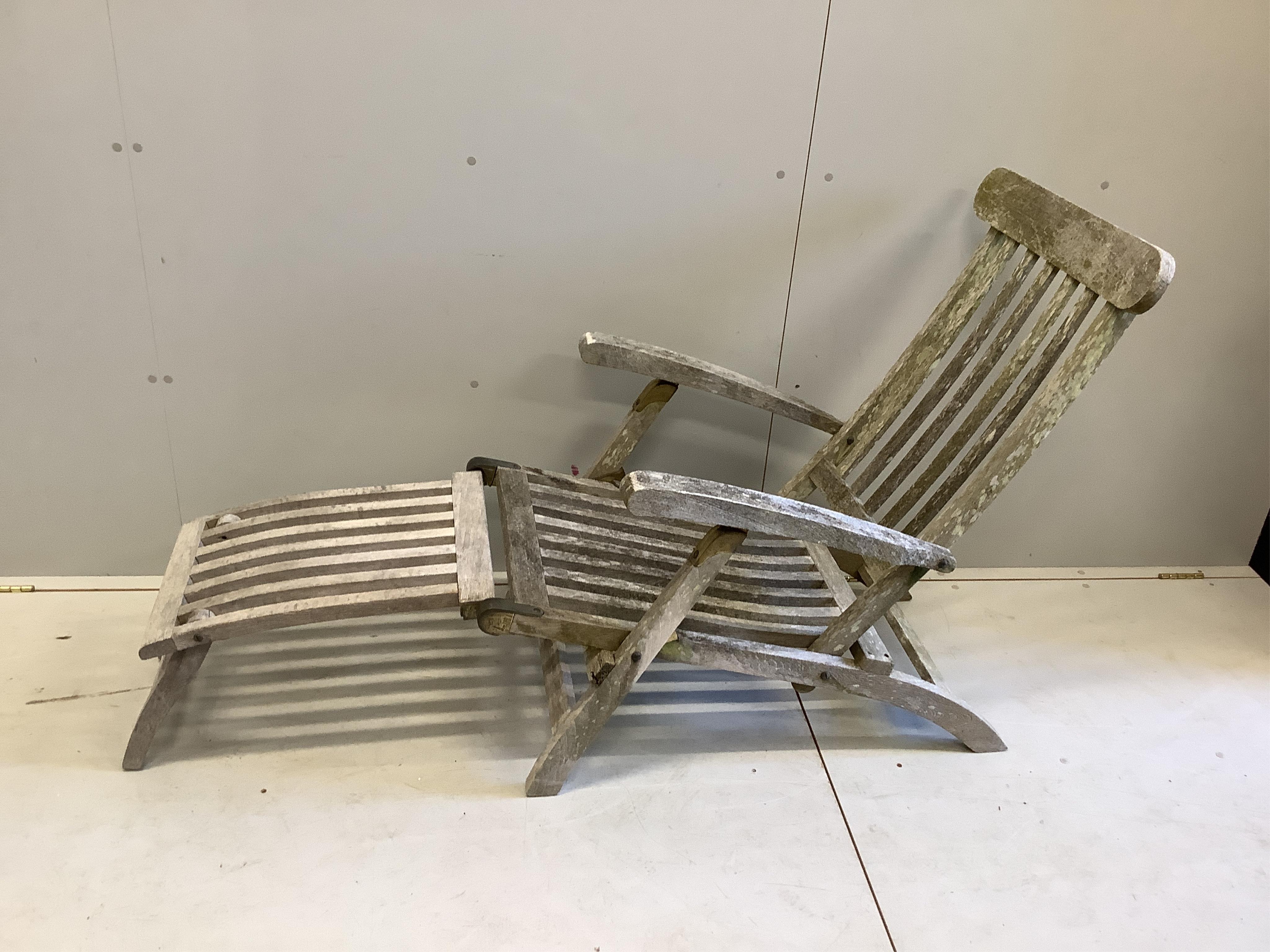 Two weathered teak steamer reclining garden chairs, height 86cm. Condition - fair-good